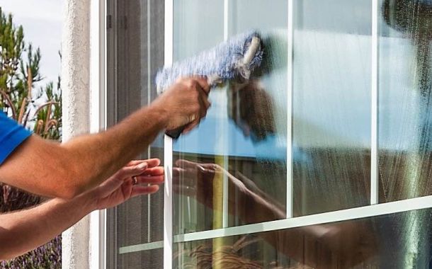 man cleaning a window