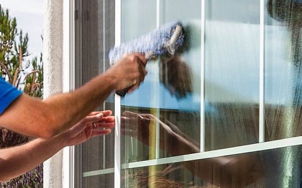 man cleaning a window